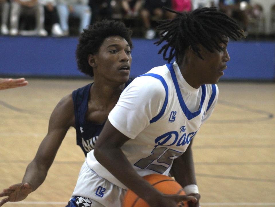 Impact Christian guard Wayne Castle (15) spins away from University Christian guard Justin Gist (3) in the District 3-2A boys basketball final.