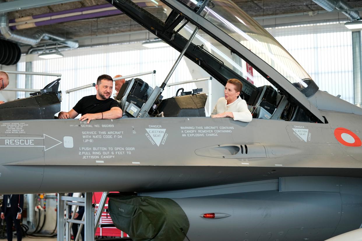 Ukrainian President Volodymyr Zelensky and Denmark's Prime Minister Mette Frederiksen sit in a F-16 fighter jet (EPA)