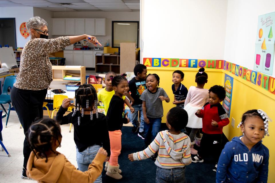 Children dance and sing with Brenda Harris, former administrator of Nanny's Multi Level Learning Center, on Wednesday, Jan. 26, 2022, in the Cincinnati neighborhood of Avondale. The child care industry has been dealing with staff shortages due to the COVID-19 pandemic.