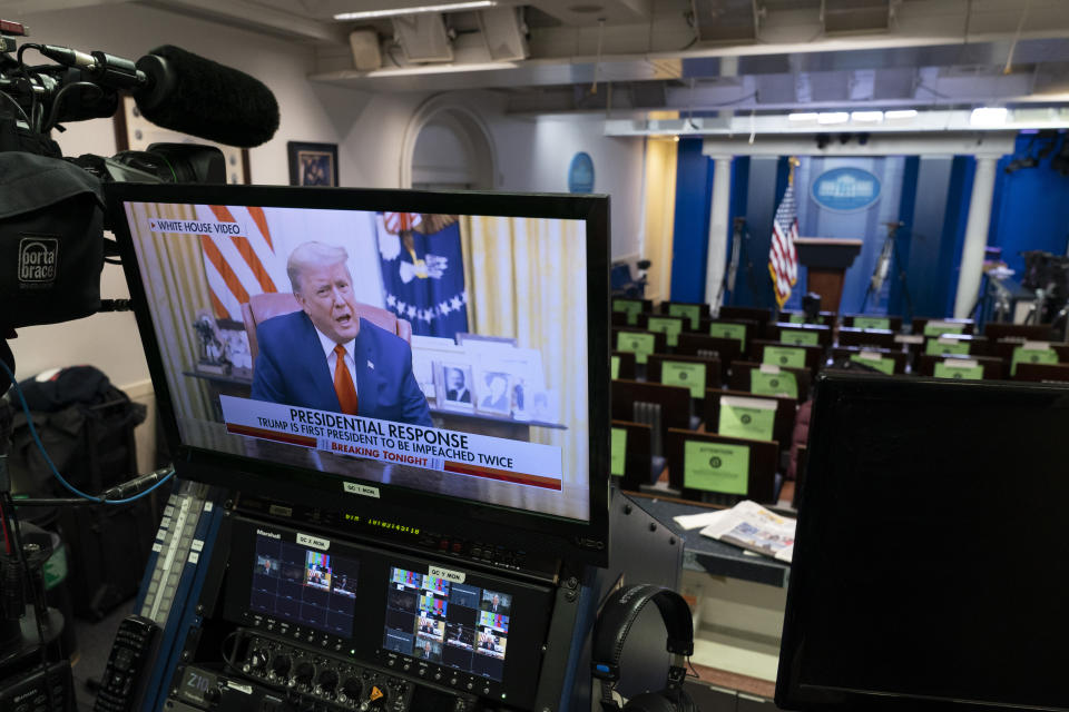 President Donald Trump condemns the violence during a recorded video on a television screen in the press briefing room at the White House. Source: Getty