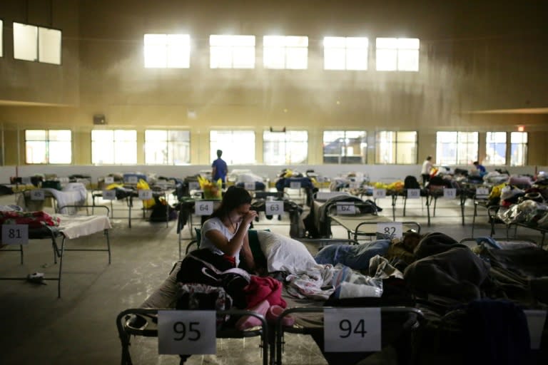 A woman on a cot at a makeshift evacuee center in Lac la Biche, Alberta on May 5, 2016