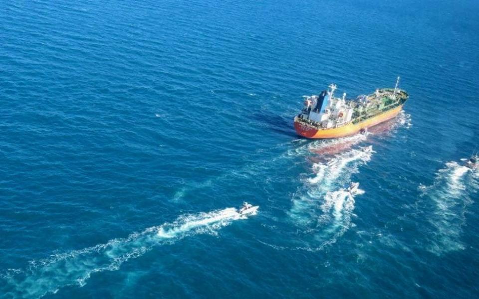 A picture obtained by AFP from the Iranian news agency Tasnim on January 4, 2021, shows the South Korean-flagged tanker being escorted by Iran's Revolutionary Guards  - AFP