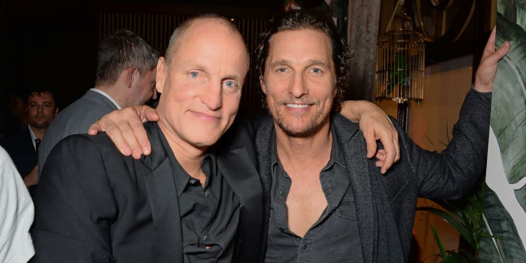 woody harrelson and matthew mcconaughey embracing while sitting at a table