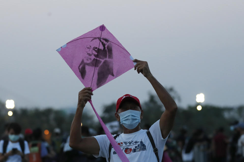 A man prepares to release a kite with an image of detained activist Panusaya Sithijirawattanakul which will be flown during a protest on the Sanam Luang grounds near the Grand Palace Saturday, March 20, 2021, in Bangkok, Thailand. Thailand's student-led pro-democracy movement is holding a rally in the Thai capital, seeking to press demands that include freedom for their leaders, who are being held without bail on charges of defaming the monarchy. (AP Photo/Sakchai Lalit)