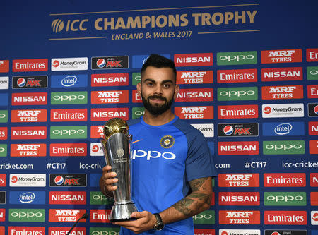 Britain Cricket - India - Virat Kohli Press Conference - The Grange Hotel, London - 25/5/17 India's Virat Kohli poses with the ICC Champions Trophy during the press conference Action Images via Reuters / Tony O'Brien Livepic