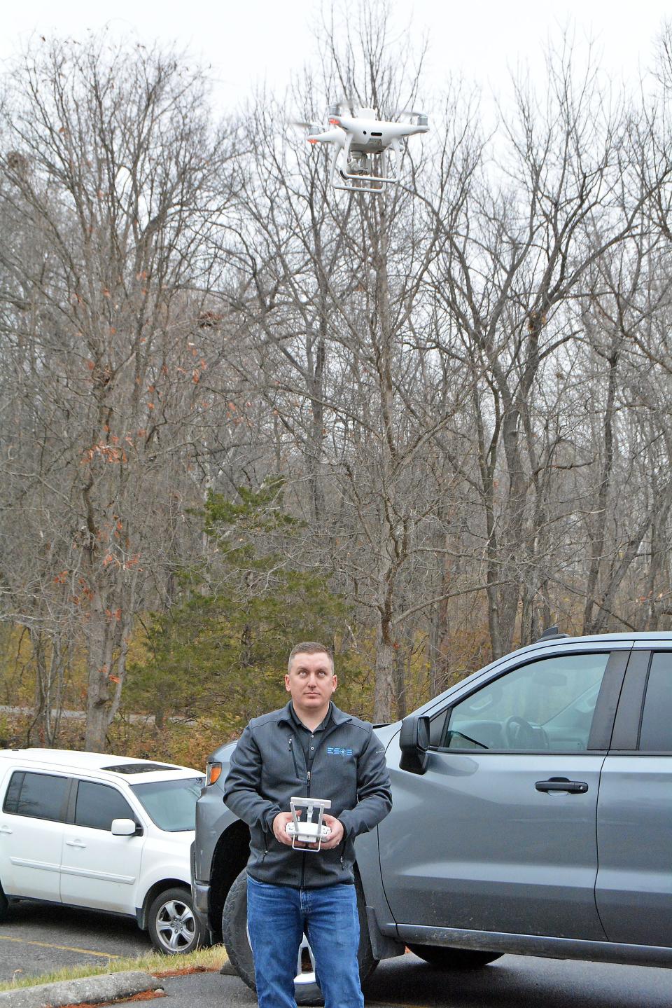 Cory Bergthold, Engineering Surveys and Services vice president of operations, briefly flys a drone about 10 feet off the ground Wednesday at the MKT trailhead on Forum Boulevard. In the coming weeks he will take aerial photography along the roadway to aid engineering plans for a widening in a not-yet four lane section of the street. 