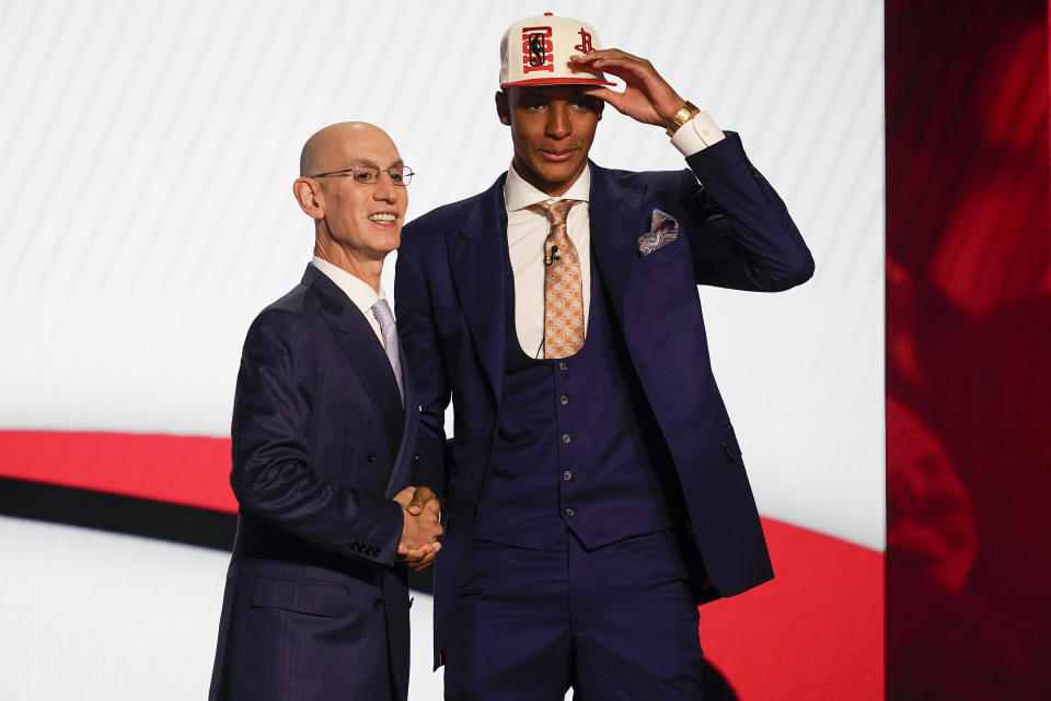 Jabari Smith Jr., right, is congratulated by NBA Commissioner Adam Silver after being selected third overall in the NBA basketball draft by the Houston Rockets, Thursday, June 23, 2022, in New York. (AP Photo/John Minchillo)