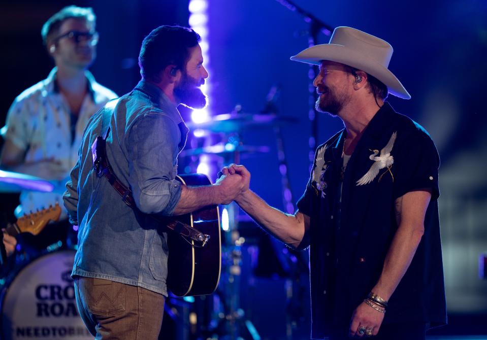 Jordan Davis, left, and NEEDTOBREATHE frontman Bear Rinehart end their song with a fist bump at the 2024 "CMT Crossroads taping with NEEDTOBREATHE and Jordan Davis at the University of Texas in Austin, Texas., Friday, April 5, 2024.