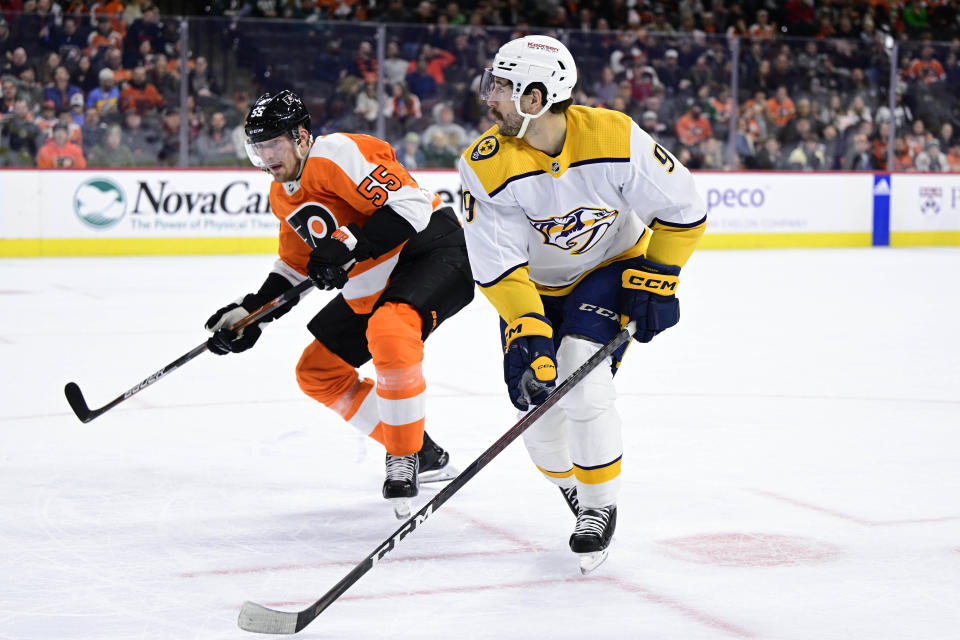 Nashville Predators' Filip Forsberg, right, skates for a puck past the defense of Philadelphia Flyers' Rasmus Ristolainen during the first period an NHL hockey game, Saturday, Feb. 11, 2023, in Philadelphia. (AP Photo/Derik Hamilton)