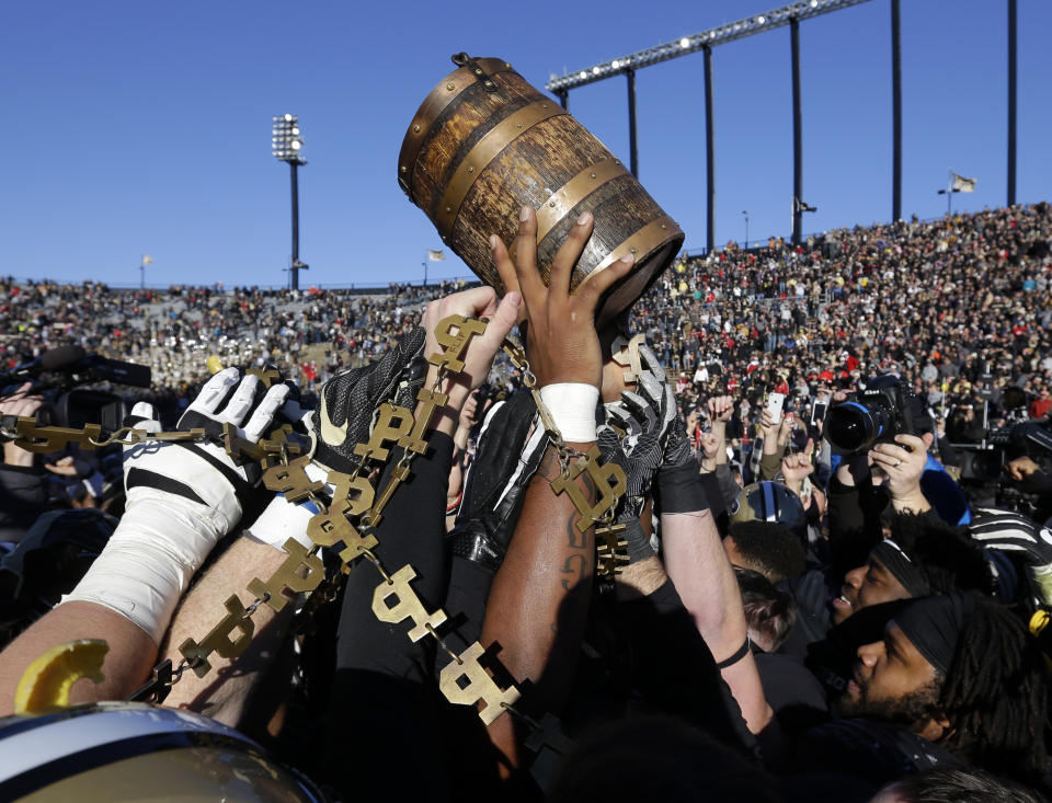 Purdue players celebrate with the Old Oaken Bucket after defeating Indiana 31-24. (AP)