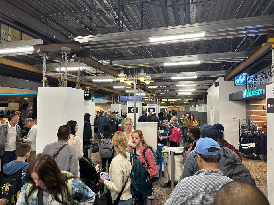 People wait to pass through the Transportation Security Administration checkpoint at Seattle-Tacoma International Airport on June 27, 2024.