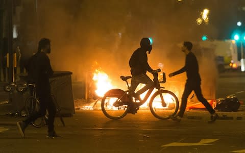Protesters take to the streets of Dalston burning bed mattresses and clash with police following the death of Rashan Charles  - Credit: ZUMA Press, Inc. / Alamy Live News