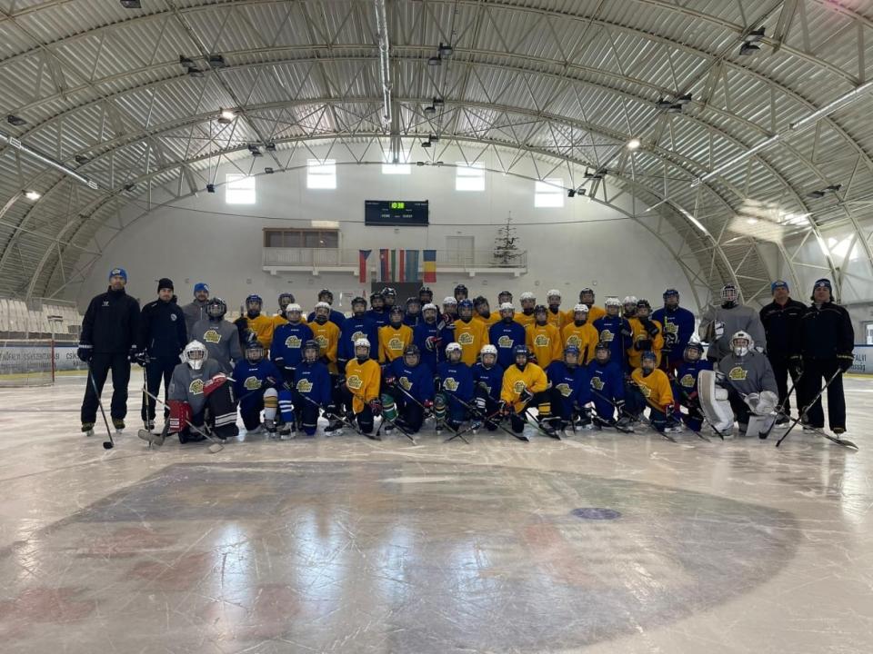 Ukrainian peewee hockey players gathered in Romania two weeks ago for training and a tryout. Yevhenii Pysarenko, far left, is their coach and has been working with Sean Bérubé in Quebec City to bring the players to the tournament in February.   (Submitted by Yevhenii Pysarenko - image credit)