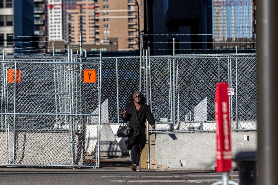 A pedestrian is seen through security barricades set up outside the Hennepin County Government Center on the third day of jury selection in the trial of former Minneapolis Police officer Derek Chauvin on March 11, 2021 in Minneapolis, Minnesota. - A Minnesota judge on March 11, 2021 added an additional murder charge against Derek Chauvin, the police officer on trial for the death of George Floyd. Chauvin, 44, is already facing charges of second-degree murder and manslaughter in connection with Floyd's May 25, 2020 death in Minneapolis. (Photo by Kerem Yucel / AFP) (Photo by KEREM YUCEL/AFP via Getty Images)