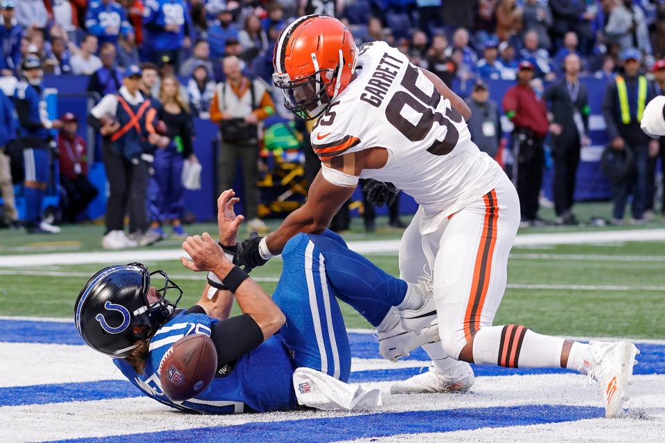 Gardner Minshew of the Indianapolis Colts fumbles the ball against Myles Garrett of the Cleveland Browns during the second quarter at Lucas Oil Stadium on October 22, 2023 in Indianapolis, Indiana.
