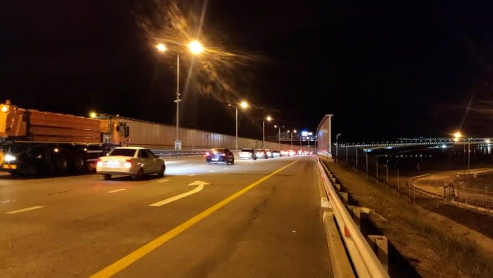 Pictured, traffic resuming on the bridge last Tuesday following an attack the previous day (Marat Khusnullin/Telegram)