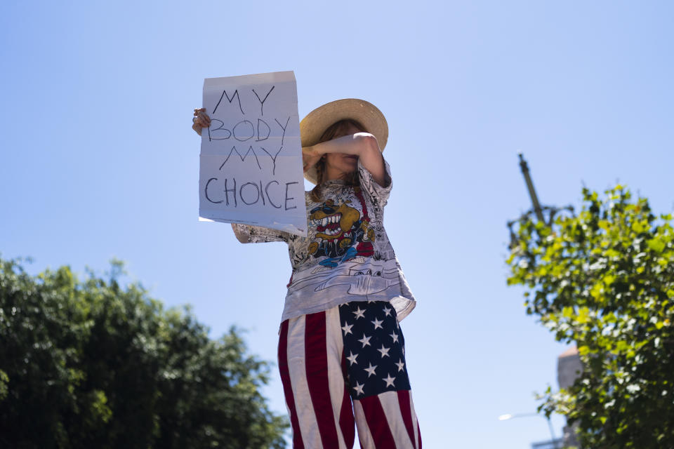 Abortion-rights advocate Eleanor Wells, 34, wipes her tears during a protest in Los Angeles, Friday, June 24, 2022. The U.S. Supreme Court's decision to end constitutional protections for abortion has cleared the way for states to impose bans and restrictions on abortion — and will set off a series of legal battles. (AP Photo/Jae C. Hong)