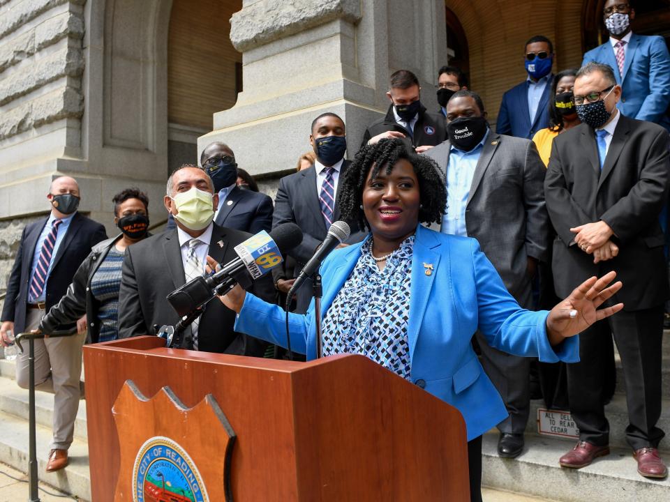 Joanna McClinton in blue outfit behind podium