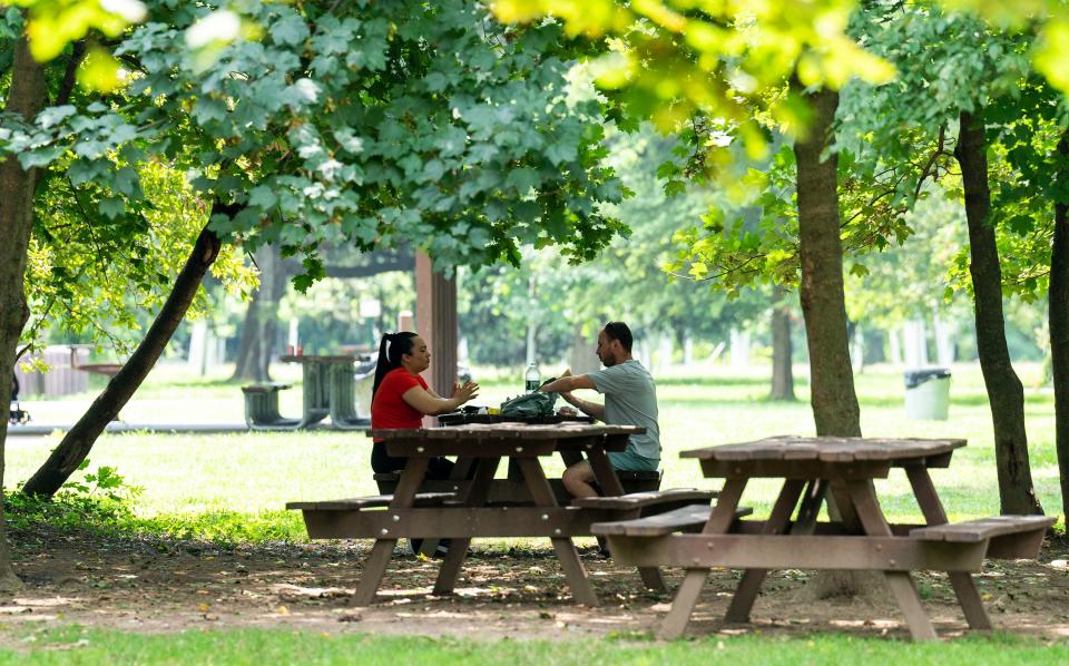 People picnicking in the shade at Neshaminy State Park in Bensalem on Thursday, July 27, 2023.