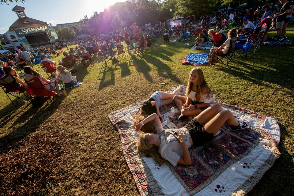 June 3, 2022; Tuscaloosa, AL, USA; The Tuscaloosa community enjoys the first Live at the Plaza concert of the season at Government Plaza, listening to the music of The Locals. Emma Kate Dickey, Sara Westbrook and Emma Sanderford rest on a blanket as they enjoy the evening. Gary Cosby Jr.-The Tuscaloosa News