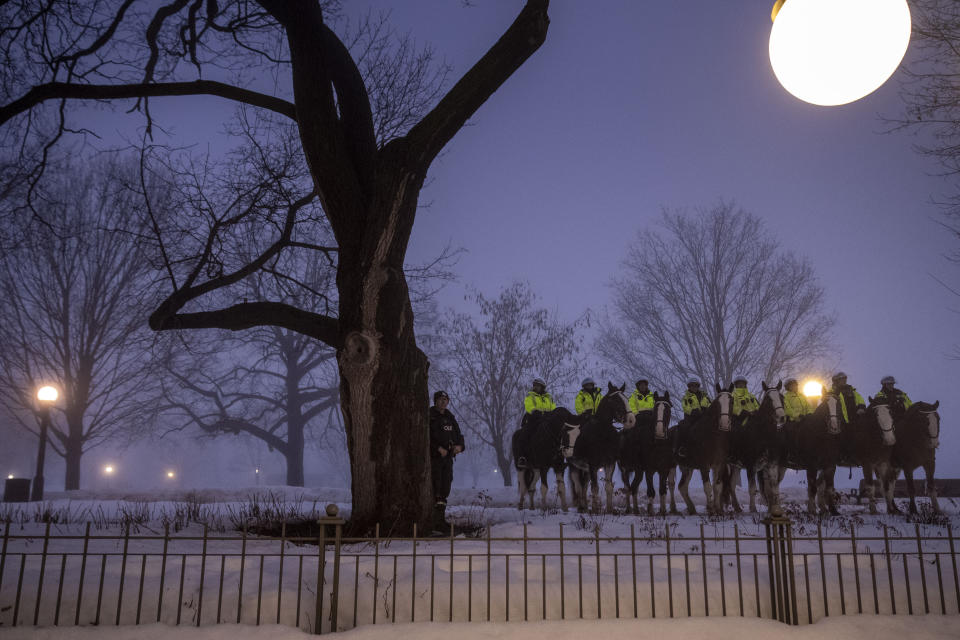 Canadian police officers on horseback watch as the motorcade for President Joe Biden and first lady Jill Biden arrive, Thursday, March 23, 2023, in Ottawa, Canada. (AP Photo/Andrew Harnik)