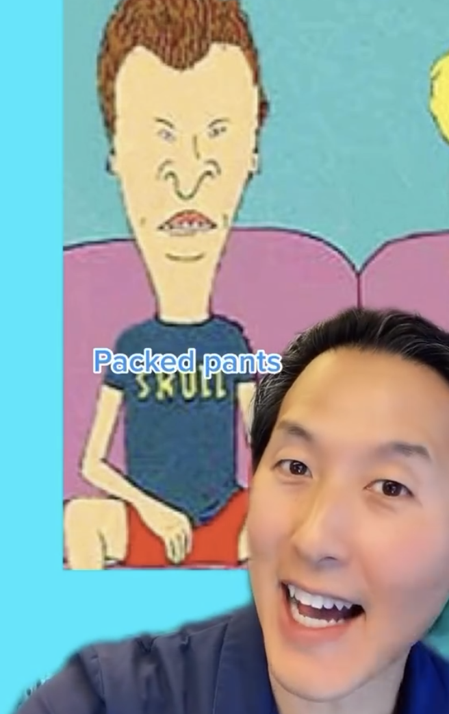 Person smiling in front of an illustration of Beavis from Beavis and Butt-Head, with text 