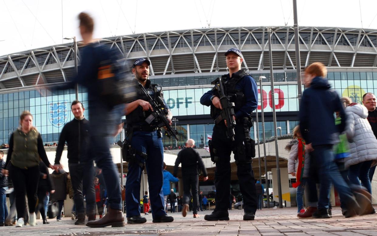 Armed police patrolled outside the national stadium - Rex Features