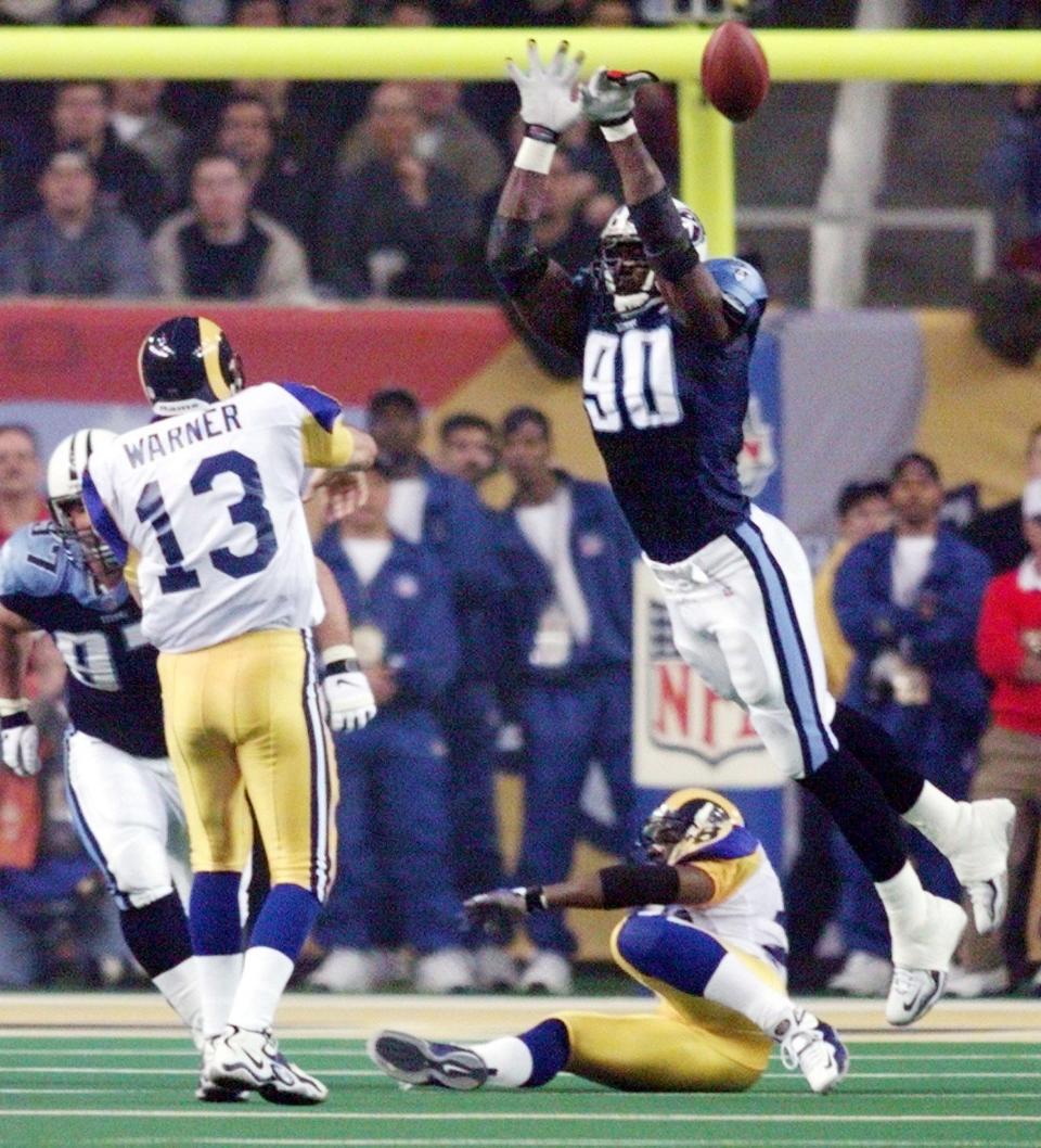 Tennessee Titans defensive end Jevon Kearse (90) blocks a pass by St. Louis Rams quarterback Kurt Warner during the 3rd quarter Jan. 30, 2000. The Titans just fell inches short in a 23-16 Rams' victory in Super Bowl XXXIV.