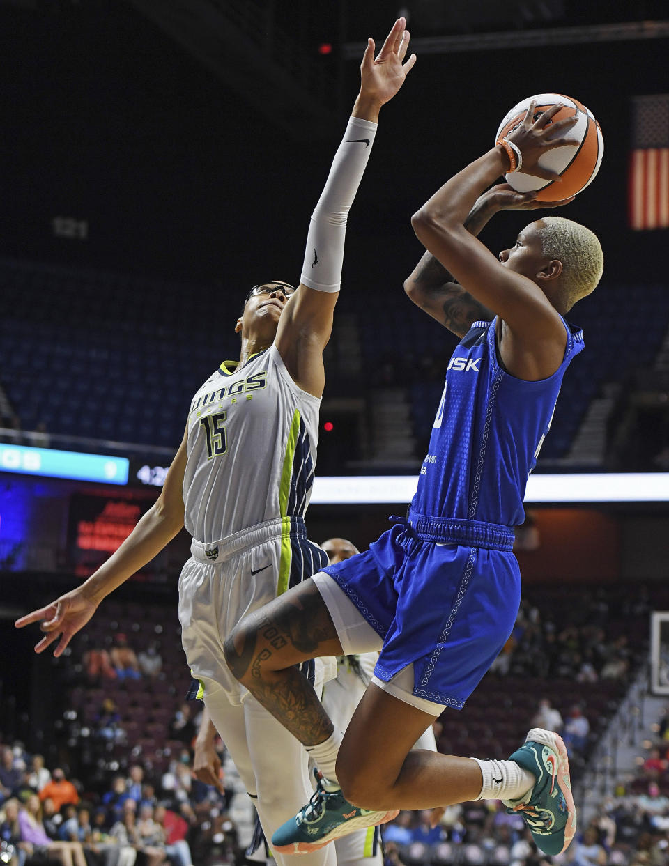 Connecticut Sun guard Courtney Williams (10) shoots over Dallas Wings guard Allisha Gray (15) during a WNBA basketball game Tuesday, May 24, 2022, in Uncasville, Conn. (Sean D. Elliot/The Day via AP)