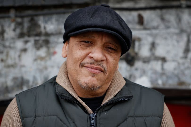 Tarik Kamhouri posing in a flat cap in West London