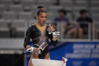 LSU's Haleigh Bryant gestures to teammates standing nearby as she prepares to compete on the uneven bars during the NCAA women's gymnastics championships in Fort Worth, Texas, Thursday, April 18, 2024. (AP Photo/Tony Gutierrez)