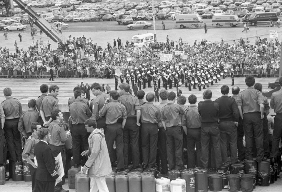 A Royal marines band, family and wellwishers greet survivors of the warships HMS Coventry, Antelope and Ardent as they arrive at Southampton on the QE2 (PA) (PA Archive)