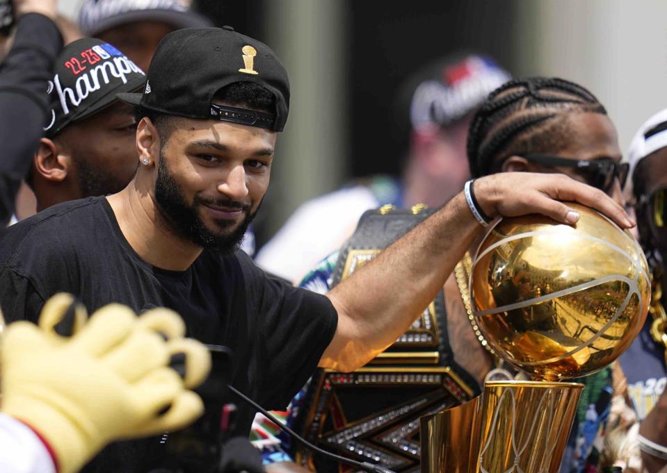 Denver Nuggets guard Jamal Murray celebrates during a rally to mark the Denver Nuggets first NBA basketball championship Thursday, June 15, 2023, in Denver. (AP Photo/Jack Dempsey)