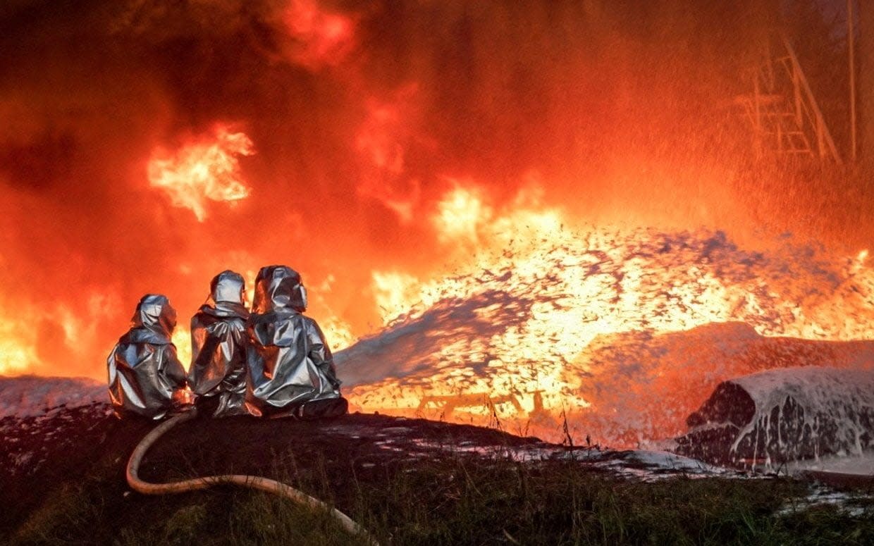 Firefighters work at a site of an infrastructure facility hit by a Russian drone strike, amid Russia's attack on Ukraine