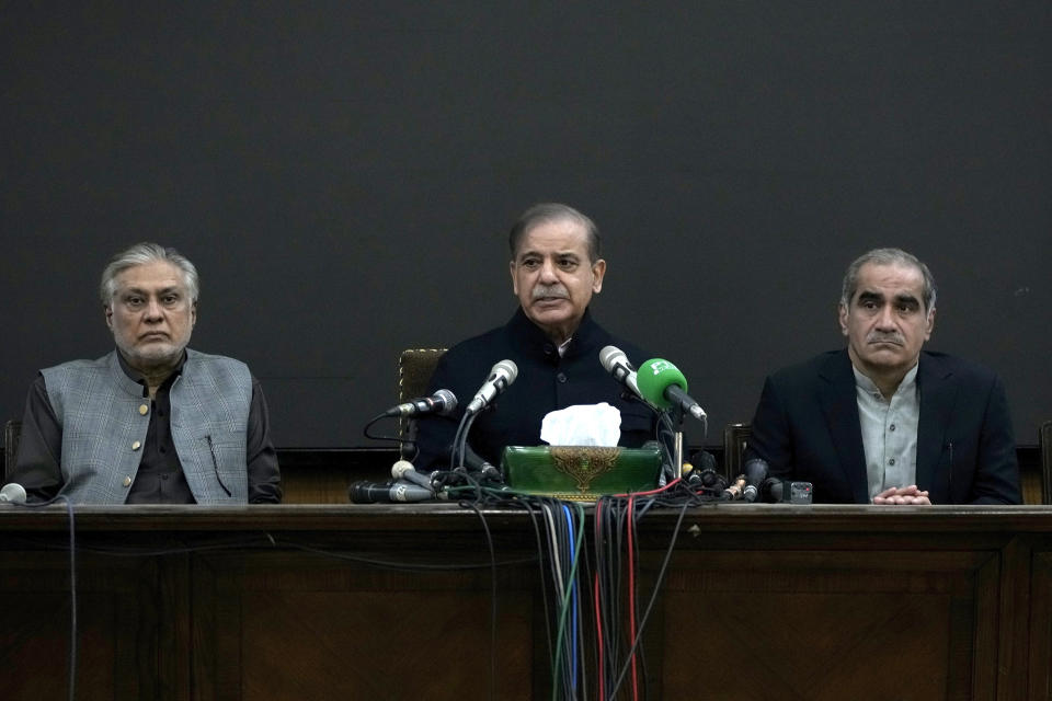 Pakistan's former Prime Minister Shehbaz Sharif, center speaks as his party aids Ishaq Dar, left, and Khawaja Saad Rafiq watch during a press conference regarding parliamentary elections, in Lahore, Pakistan, Tuesday, Feb. 13, 2024. Sharif, the main political rival of ex-Pakistani premier Imran Khan challenged him Tuesday to form a government if he had the support of the majority of the newly elected lawmakers in the parliament. (AP Photo/K.M. Chaudary)