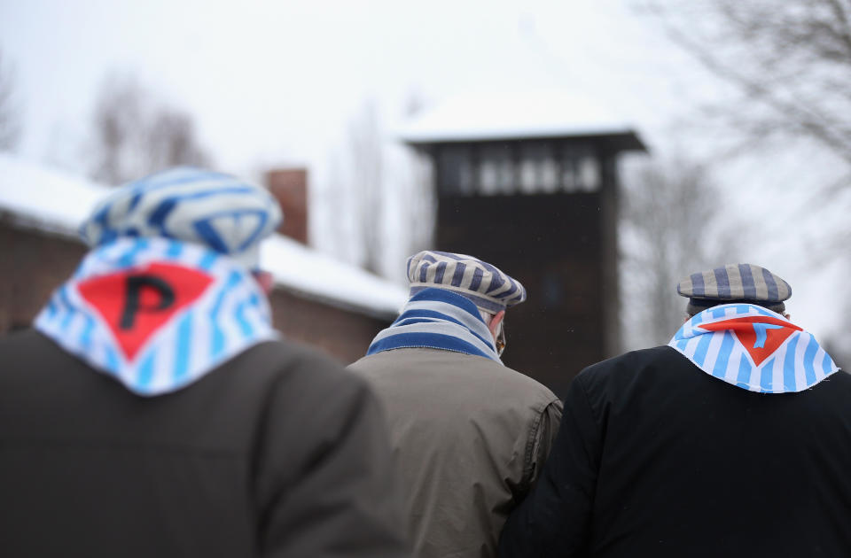 Members of an association of Auschwitz concentration camp survivors walk past a guard tower as they depart after laying wreaths at the execution wall at the former Auschwitz I concentration camp on January 27, 2015 in Oswiecim, Poland. International heads of state, dignitaries and over 300 Auschwitz survivors are attending the commemorations for the 70th anniversary of the liberation of Auschwitz by Soviet troops on 27th January, 1945. Auschwitz was among the most notorious of the concentration camps run by the Nazis during WWII and whilst it is impossible to put an exact figure on the death toll it is alleged that over a million people lost their lives in the camp, the majority of whom were Jewish.