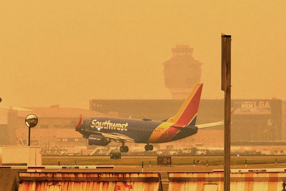 A Southwest airliner approaches LaGuardia Airport in New York, Wednesday, June 7, 2023. The Federal Aviation Administration paused some flights bound for LaGuardia Airport and slowed planes to Newark Liberty and Philadelphia because the smoke from wildfires in Canada was limiting visibility. It also contributed to delayed arrivals at Dulles International Airport outside Washington.
