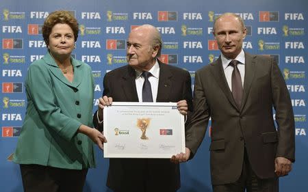Russia's President Vladimir Putin (R), Brazil's President Dilma Rousseff (L) and FIFA President Sepp Blatter take part in the official hand over ceremony for the 2018 World Cup scheduled to take place in Russia, in Rio de Janeiro July 13, 2014. REUTERS/Alexey Nikolsky/RIA Novosti/Kremlin