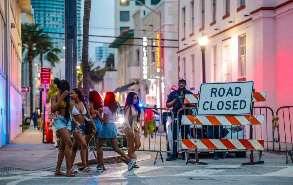 A police officer stands watch at a road closure along Ocean Drive during spring break on Miami Beach, Florida on Saturday, March 16, 2024.