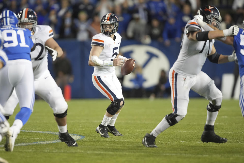 Virginia quarterback Brennan Armstrong (5) looks to pass the ball during the second half, of an NCAA college football game against BYU Saturday, Oct. 30, 2021, in Provo, Utah. (AP Photo/George Frey)