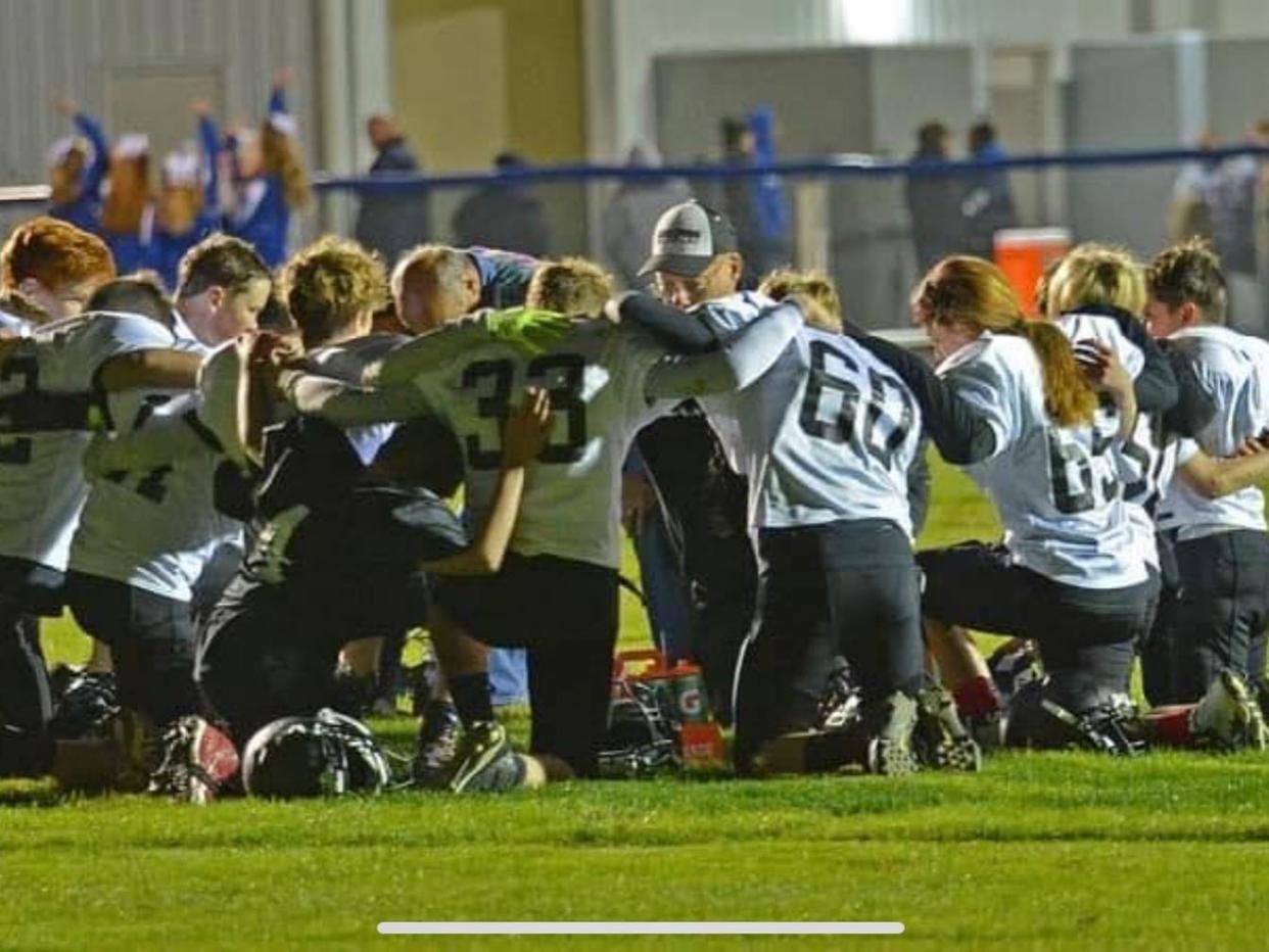 Student athletes and members of Fellowship of Christian Athletes are shown on the field.