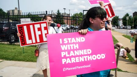 Pro-Choice and Pro-Life protesters stand outside of Planned Parenthood as a deadline looms to renew the license of Missouri's sole remaining Planned Parenthood clinic in St. Louis, Missouri