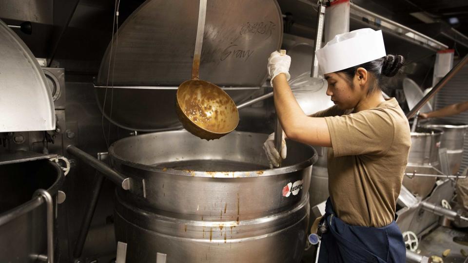 Culinary Specialist Nina Mae Castro prepares food aboard the amphibious assault ship Bataan, which won an award for food service excellence. (Seaman George Fotopoulos/Navy)