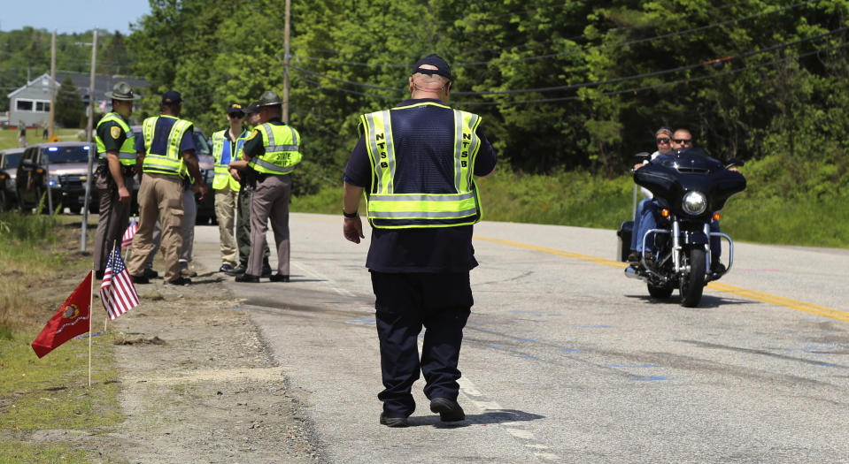 FILE - Members of the National Transportation Safety Board and the New Hampshire State Police investigate the scene of Friday's collision involving a pick-up truck and numerous motorcycles in Randolph, N.H., Sunday, June 23, 2019. Volodymyr Zhukovskyy, a commercial truck driver ordered deported to Ukraine is trying to get his driving privileges back now that he's been acquitted of causing the deaths of seven motorcyclists in New Hampshire in a 2019 crash. (Peter Knudson/National Transportation Safety Board via AP)
