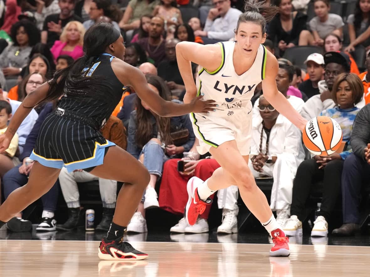 Chatham, Ont., native Bridget Carleton of the Minnesota Lynx drives past Dana Evans of the Chicago Sky during the first half of a WNBA pre-season game at Scotiabank Arena in Toronto on Saturday. (Chris Young/The Canadian Press - image credit)
