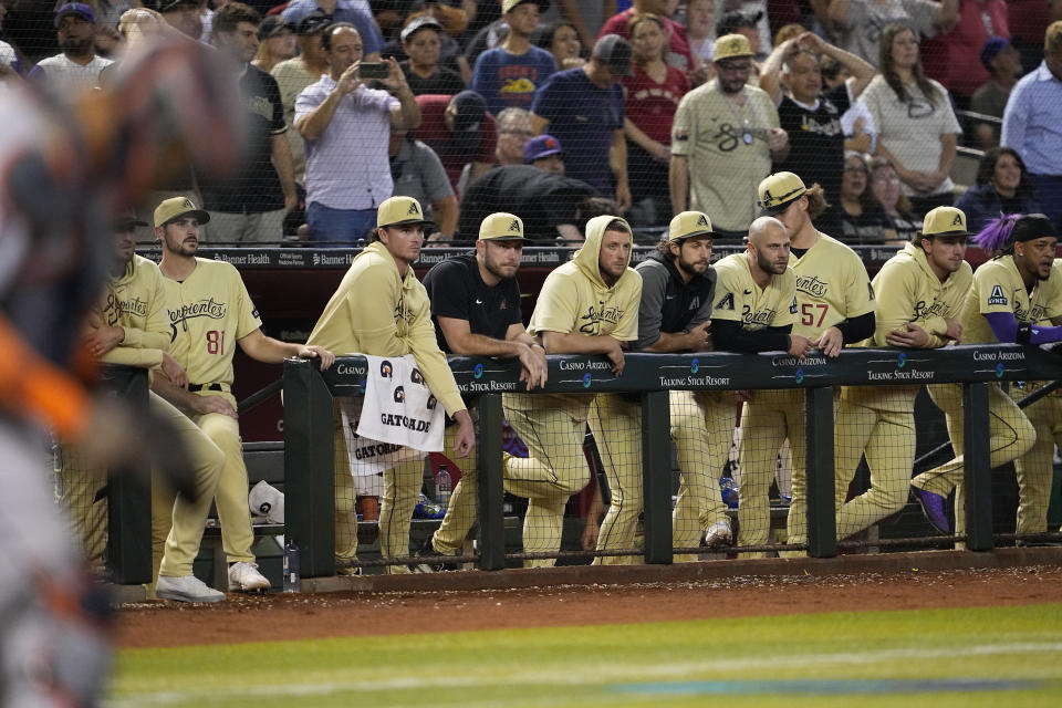 Arizona Diamondbacks players watch after the final out after a baseball game against the Houston Astros, Friday, Sept. 29, 2023, in Phoenix. The Astros defeated the Diamondbacks 2-1. (AP Photo/Matt York)