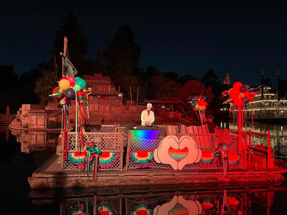 floating rainbow boat on river in disney with mickey hands in the shape of a heart