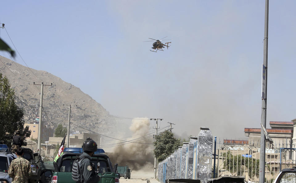 An MD 530F military helicopter targets a house where suspected attackers are hiding in Kabul, Afghanistan, Tuesday, Aug. 21, 2018. The Taliban fired rockets toward the presidential palace in Kabul Tuesday as President Ashraf Ghani was giving his holiday message for the Muslim celebrations of Eid al-Adha, said police official Jan Agha. (AP Photo/Rahmat Gul)