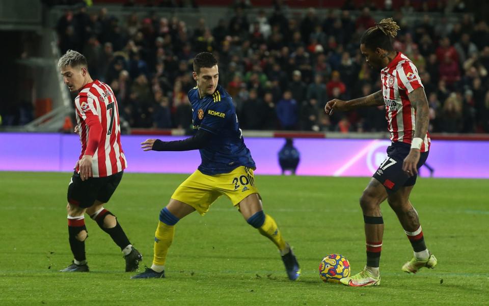 Diogo Dalot of Manchester United in action with Sergi Canos and Ivan Toney of Brentford during the Premier League match between Brentford and Manchester United at Brentford Community Stadium on January 19, 2022 in Brentford, England -  Matthew Peters/Manchester United via Getty Images