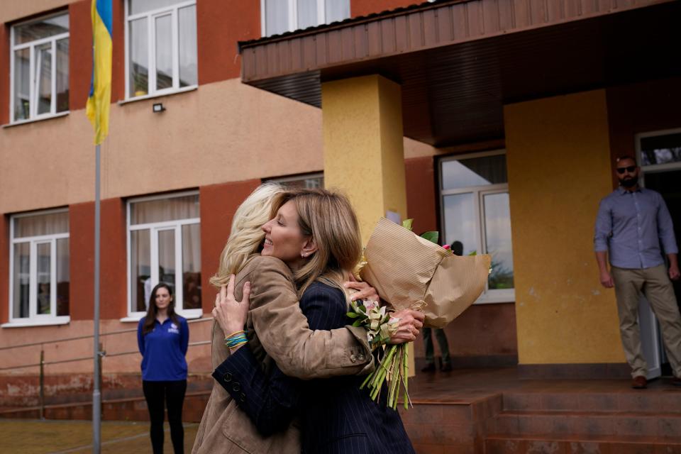 First lady Jill Biden hugs Olena Zelenska, spouse of Ukrainian's President Volodymyr Zelenskyy, outside of School 6, a public school that has taken in displaced students in Uzhhorod, Ukraine, Sunday, May 8, 2022. (AP Photo/Susan Walsh, Pool)